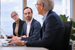 © Johnér - Businessman and businesswoman listening to senior colleague in office