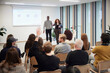© Johnér - Audience communicating with coworkers during presentation in office