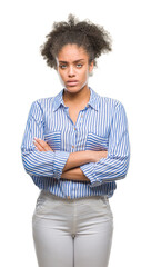 Sticker - Young afro american woman over isolated background skeptic and nervous, disapproving expression on face with crossed arms. Negative person.