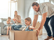 © peopleimages.com - Family, man and girl with box in new home for relocation, playing or real estate. Children, parents and dad with daughter for property investment, happiness or bonding together in living room