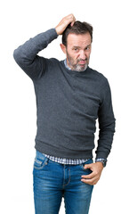 Canvas Print - Handsome middle age senior man wearing a sweater over isolated background confuse and wonder about question. Uncertain with doubt, thinking with hand on head. Pensive concept.