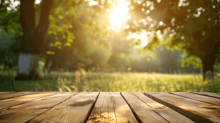 Poster - A wooden table with a view of trees and a bright sun blurred evening background, wooden table top and soft summer sun and cozy park backdrop, empty place mock up table. Sunny table nature background