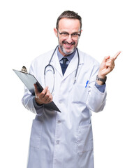 Wall Mural - Middle age senior hoary doctor man holding clipboard over isolated background very happy pointing with hand and finger to the side