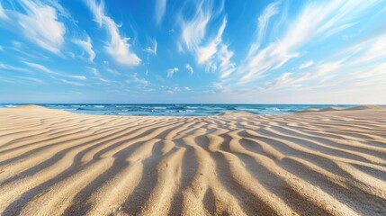 Wall Mural - Pattern of wind blown waves on sand with blue sky view