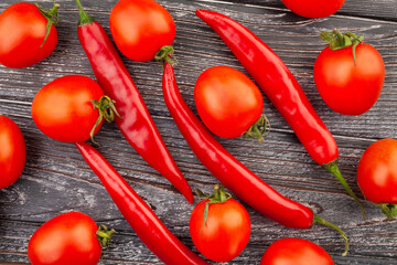 Wall Mural - chili pepper cherry tomato on wood background top view