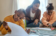 © peopleimages.com - Boy, black child and book in living room for homework, learning literature or education. Family, young kids with woman parent on floor for teaching, growth development or bonding together in home
