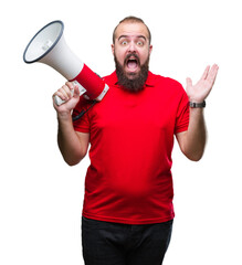 Sticker - Young caucasian man shouting through megaphone over isolated background very happy and excited, winner expression celebrating victory screaming with big smile and raised hands