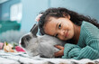 © DavisShared/peopleimages.com - Girl, child and rabbit in home portrait for love and emotional support, pet care and hug in bedroom. Female person, stroke and embrace bunny for affection, comfortable and rub fur of domestic animal