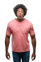 Sticker - Afro american man over isolated background afraid and shocked with surprise expression, fear and excited face.