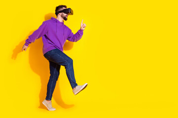 Wall Mural - Photo of nice young funny man wear purple stylish clothes vr glasses headset empty space isolated on yellow color background