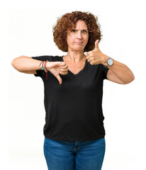 Poster - Beautiful middle ager senior woman over isolated background Doing thumbs up and down, disagreement and agreement expression. Crazy conflict