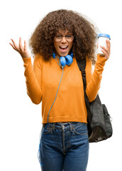 Canvas Print - African american student woman happy and surprised cheering expressing wow gesture