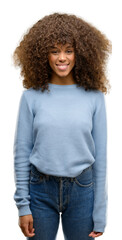 Sticker - African american woman wearing a sweater with a happy and cool smile on face. Lucky person.