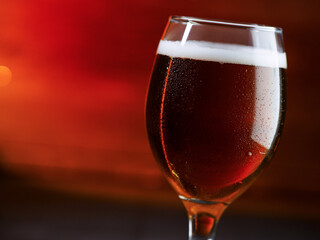 Wall Mural - Beer glass on a red background. Amber Ale, copy space