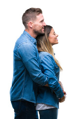 Wall Mural - Young couple in love over isolated background looking to side, relax profile pose with natural face with confident smile.