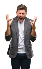 Canvas Print - Young handsome business man over isolated background celebrating mad and crazy for success with arms raised and closed eyes screaming excited. Winner concept