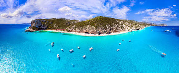 Wall Mural - Best and most beautiful beaches of Sardegna island (Italy) - Cala Luna in gulf of Orosei .  Aerial panoramic drone view of white sandy beach , caves and turquoise sea