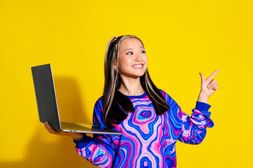 Sticker - Portrait of nice woman with dyed hair dressed print shirt holding laptop look directing empty space isolated on yellow color background