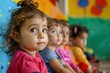 © Bijac - diverse group of wideeyed toddlers sitting in a colorful classroom captivated by an unseen teachers lesson
