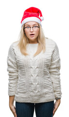 Poster - Young caucasian woman wearing christmas hat over isolated background afraid and shocked with surprise expression, fear and excited face.