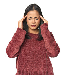 Wall Mural - Simple portrait of a young Latina touching temples and having headache.