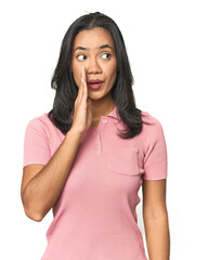 Wall Mural - simple portrait of a young latina is saying a secret hot braking news and looking aside