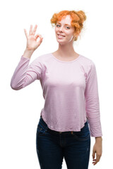 Canvas Print - Young redhead woman smiling positive doing ok sign with hand and fingers. Successful expression.