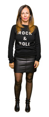 Wall Mural - beautiful middle age woman wearing rock and roll sweater relaxed with serious expression on face. si