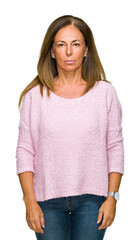 Wall Mural - beautiful middle age adult woman wearing winter sweater over isolated background with serious expres