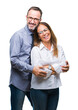 © Krakenimages.com - Middle age hispanic couple in love wearing glasses over isolated background happy face smiling with crossed arms looking at the camera. Positive person.