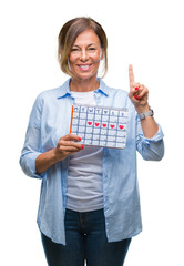 Sticker - Middle age senior hispanic woman holding menstruation calendar over isolated background surprised with an idea or question pointing finger with happy face, number one