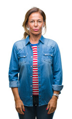 Wall Mural - middle age senior hispanic woman over isolated background with serious expression on face. simple an