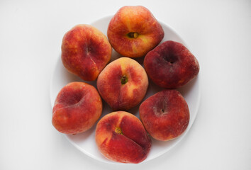 Wall Mural - Flat peaches on a white background. Peaches in a package.