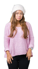 Poster - Young beautiful brunette woman wearing sweater and winter hat over isolated background depressed and worry for distress, crying angry and afraid. Sad expression.