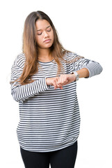 Poster - Young beautiful brunette woman wearing stripes sweater over isolated background Checking the time on wrist watch, relaxed and confident