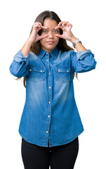 Sticker - Young beautiful brunette woman wearing blue denim shirt over isolated background Trying to open eyes with fingers, sleepy and tired for morning fatigue