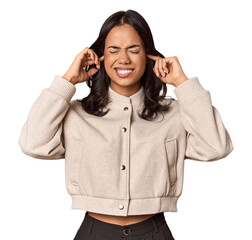 Wall Mural - Young filipino woman covering ears with fingers, stressed and desperate by a loudly ambient.