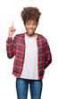 © Krakenimages.com - Beautiful young african american woman wearing glasses over isolated background pointing finger up with successful idea. Exited and happy. Number one.