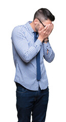 Canvas Print - Young business man wearing glasses over isolated background with sad expression covering face with hands while crying. Depression concept.