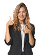 © Asier - Young businesswoman in a suit raising both thumbs up, smiling and confident.
