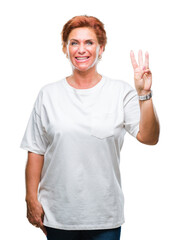 Poster - Atrractive senior caucasian redhead woman over isolated background showing and pointing up with fingers number three while smiling confident and happy.