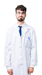 Wall Mural - Young professional scientist man wearing white coat over isolated background puffing cheeks with funny face. Mouth inflated with air, crazy expression.