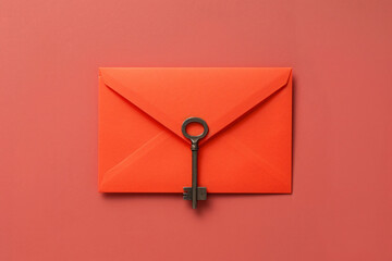 Poster - orange envelope with key on orange background flat lay top view


