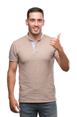 Poster - Handsome young man happy with big smile doing ok sign, thumb up with fingers, excellent sign