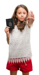 Poster - Brunette hispanic girl holding passport of Canada with open hand doing stop sign with serious and confident expression, defense gesture