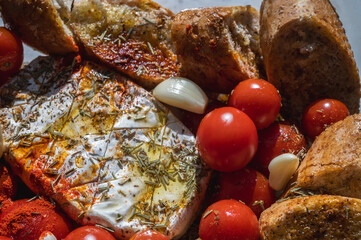 Camembert cheese with vegetables, cherry tomatoes, spices, bread, croutons and garlic, quick snack, top view