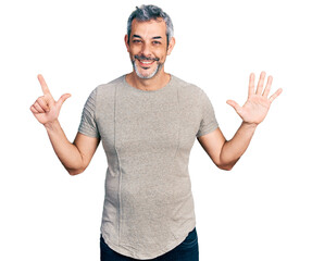 Sticker - Middle age hispanic with grey hair wearing casual grey t shirt showing and pointing up with fingers number seven while smiling confident and happy.