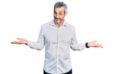 Canvas Print - Middle age hispanic with grey hair wearing casual white shirt smiling showing both hands open palms, presenting and advertising comparison and balance