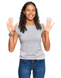 © Krakenimages.com - Young african american girl wearing casual clothes showing and pointing up with fingers number ten while smiling confident and happy.
