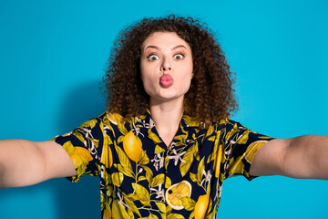 Wall Mural - Photo of cheerful pretty lady dressed print shirt tacking selfie sending you kiss empty space isolated blue color background
